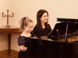 Christmas Carols Concert 2022 Unisono Music Academy 2022, Grand Piano and music teacher