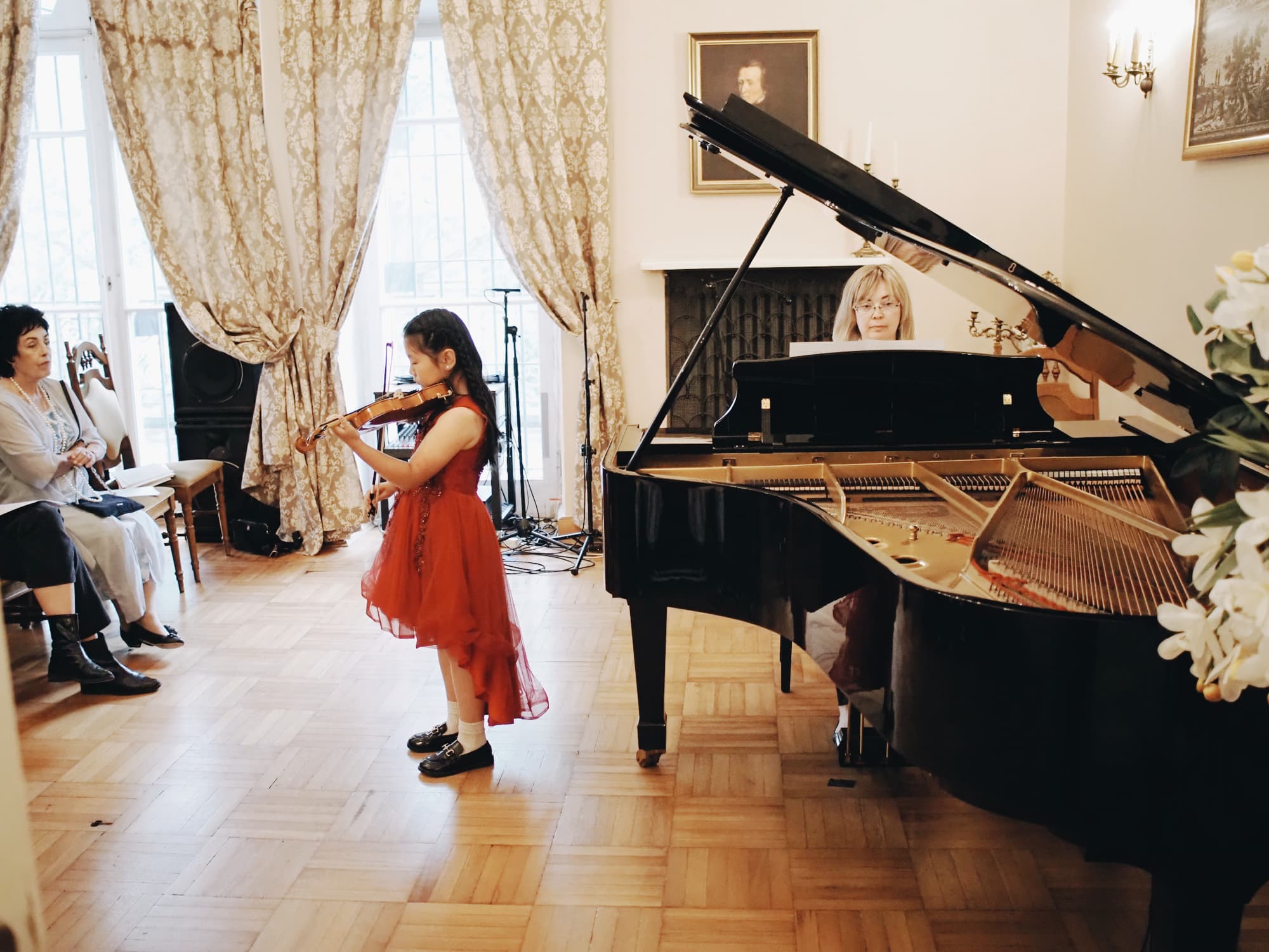 Girl in a red dress playing the violin A young violinist in a red dress performing at the Annual Concert of 2026