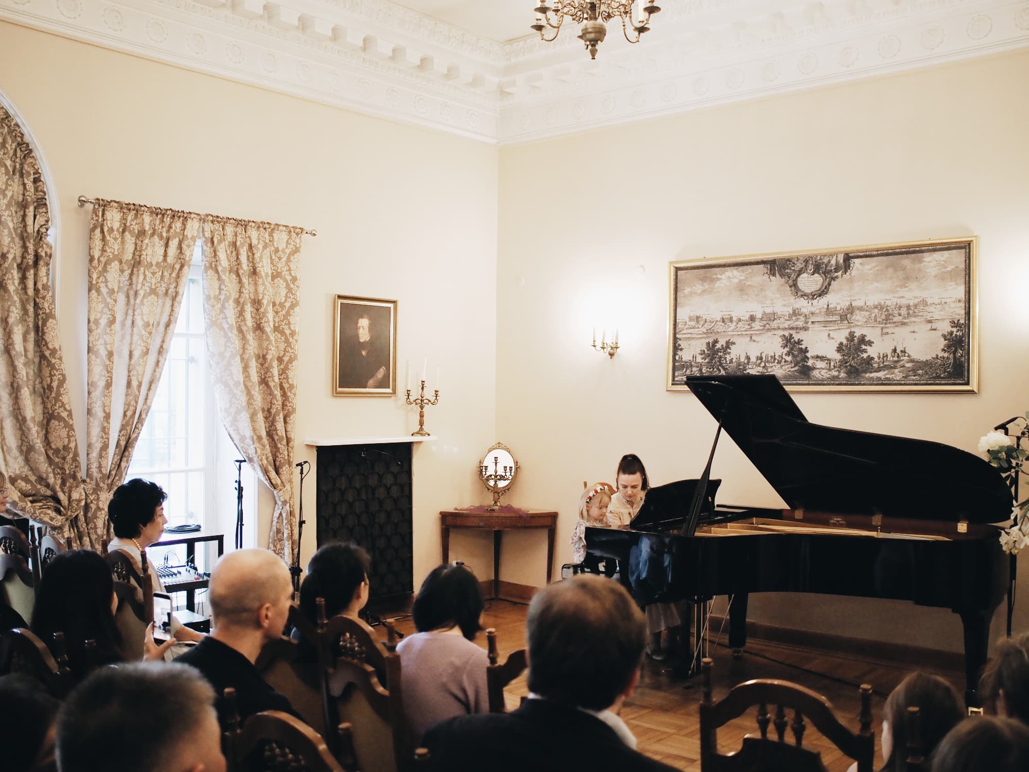 Child at the grand piano A small child playing the grand piano at the Annual Concert of 2026